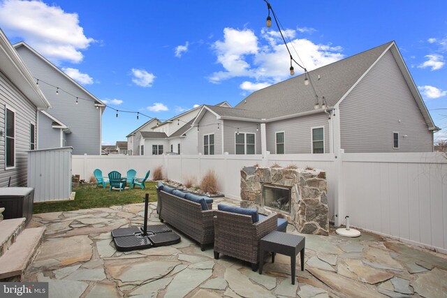 view of patio / terrace featuring an outdoor living space with a fireplace