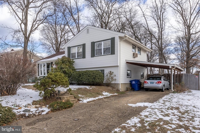 view of snow covered exterior with a carport