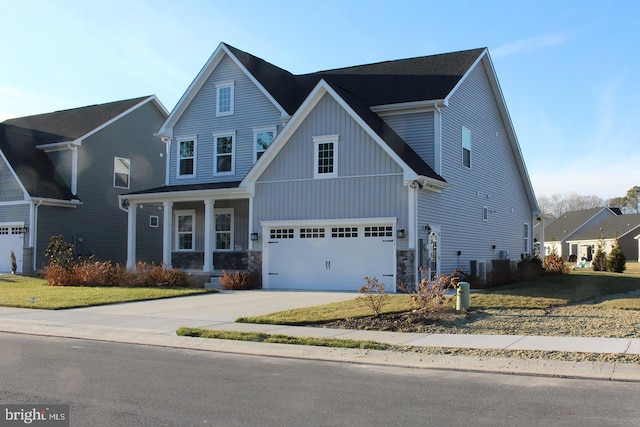 view of front facade with a porch, a garage, and a front lawn