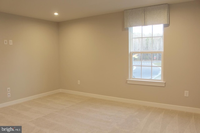 empty room with a healthy amount of sunlight and carpet flooring