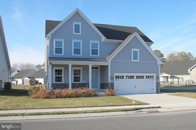 view of front facade with central AC unit, a garage, and a front yard