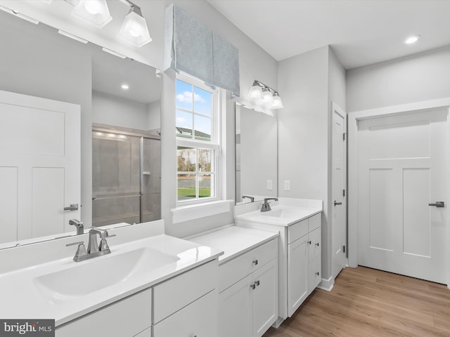37946 Oneida Way S, Frankford, DE 19945 - full bathroom featuring two vanities, wood finished floors, a sink, and a stall shower