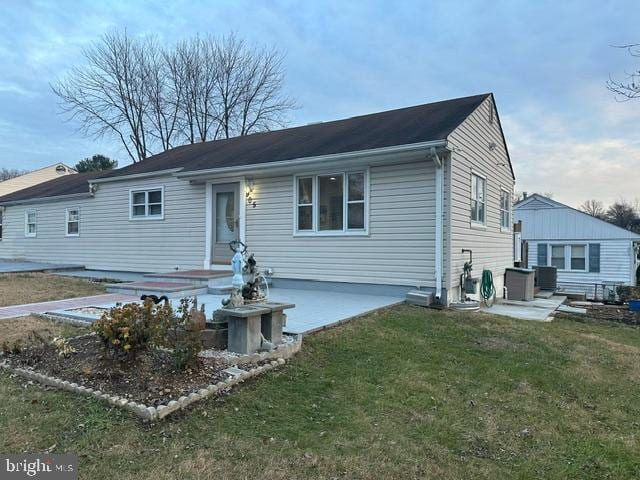 view of front of home with a patio and a front yard