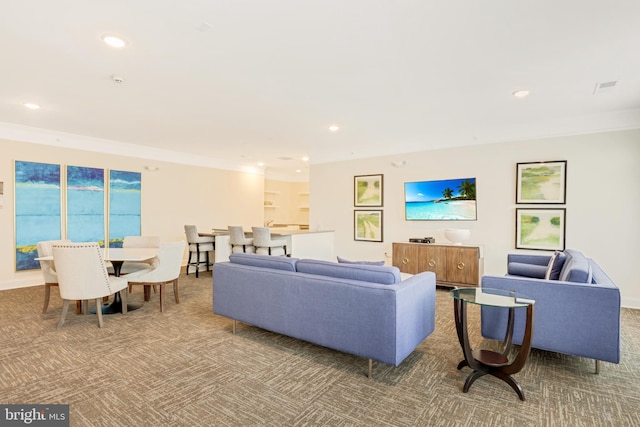 carpeted living room with crown molding