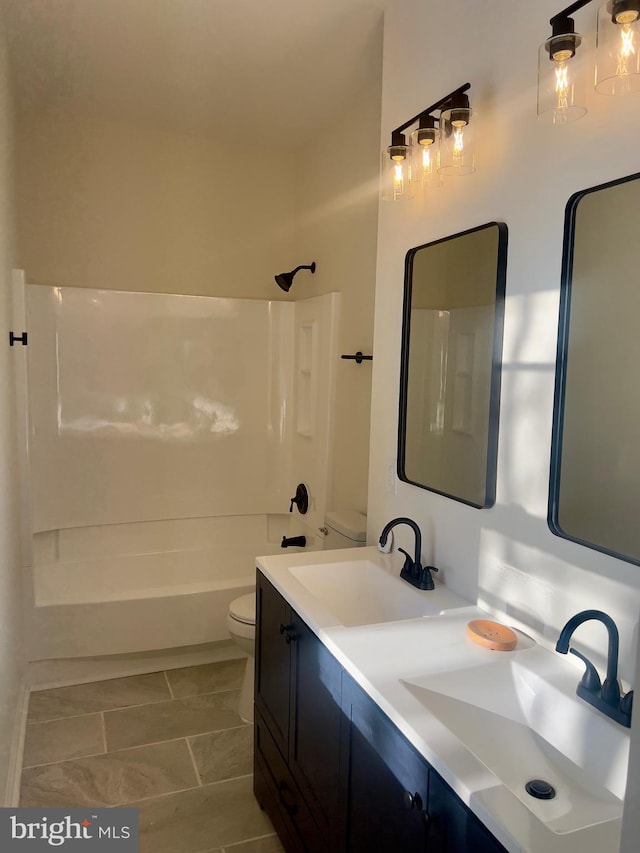 full bathroom with vanity, toilet, and washtub / shower combination