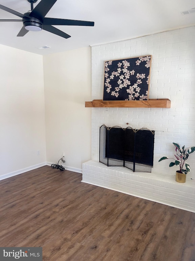 living room with ceiling fan, dark hardwood / wood-style flooring, and a fireplace