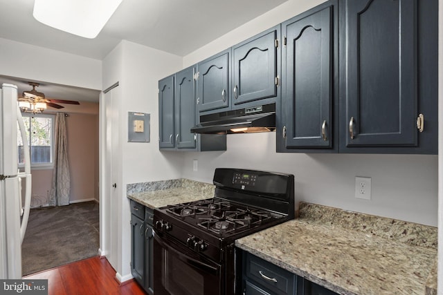 kitchen featuring light stone counters, gas stove, ceiling fan, dark wood-type flooring, and white fridge