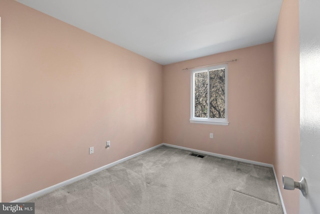 unfurnished room featuring light colored carpet