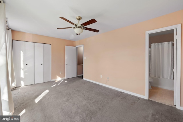 unfurnished bedroom with ensuite bathroom, ceiling fan, light colored carpet, and a closet