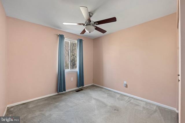 carpeted empty room featuring ceiling fan