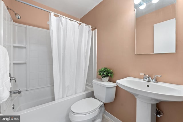 bathroom featuring shower / bath combination with curtain and toilet