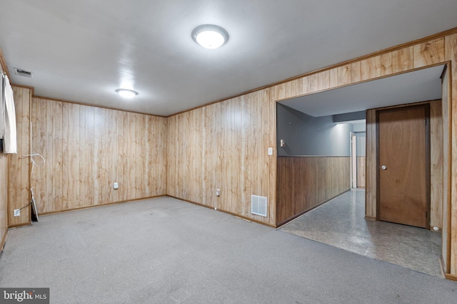 unfurnished room with wooden walls