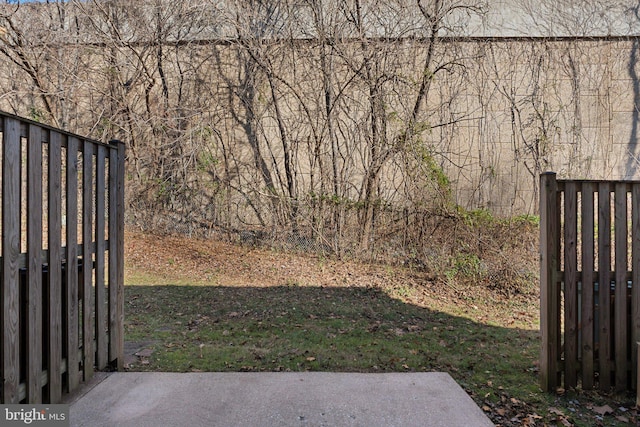 view of gate featuring a yard