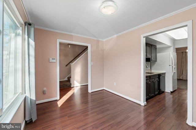 empty room featuring ornamental molding and dark wood-type flooring