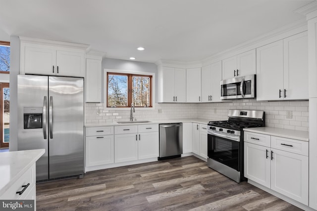 kitchen featuring appliances with stainless steel finishes, white cabinetry, and sink