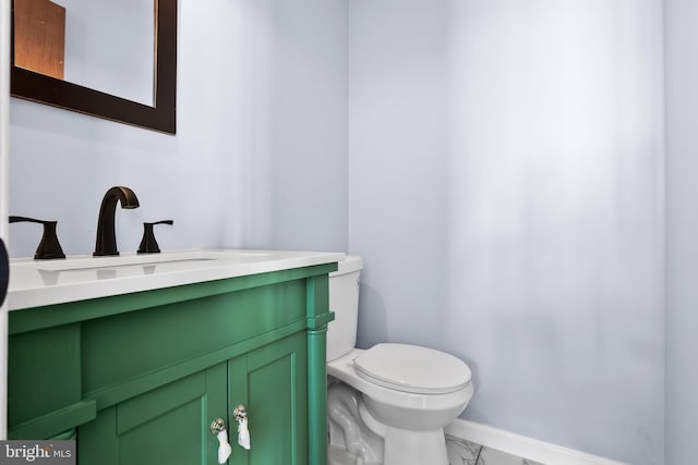 bathroom featuring toilet and vanity