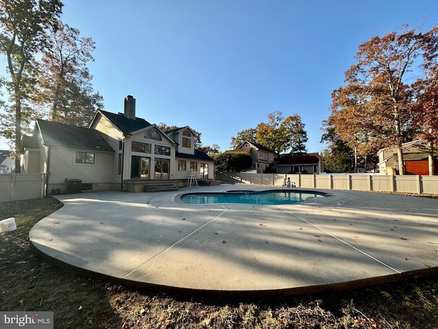 view of swimming pool with a patio and central AC unit