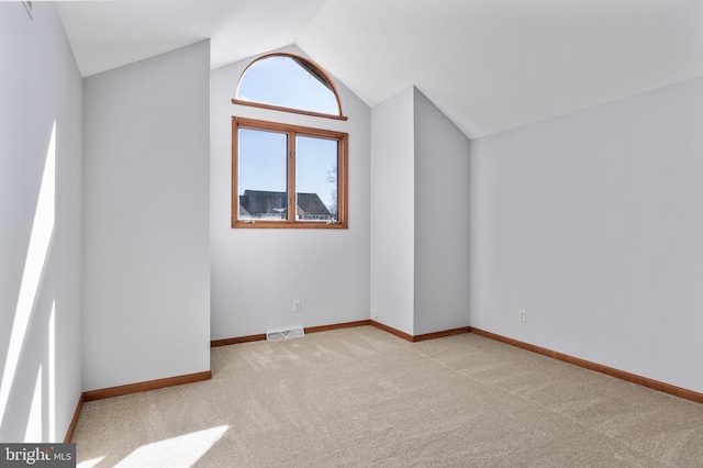 additional living space with lofted ceiling and light carpet