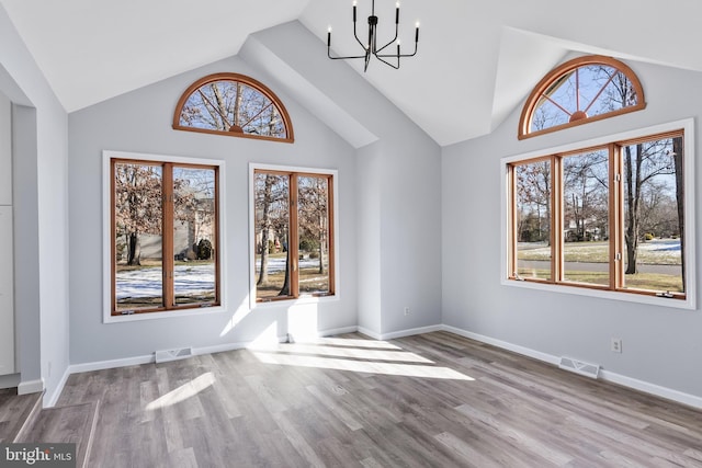 interior space with vaulted ceiling, light hardwood / wood-style floors, and a notable chandelier