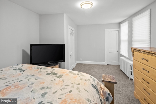 bedroom featuring dark carpet and radiator