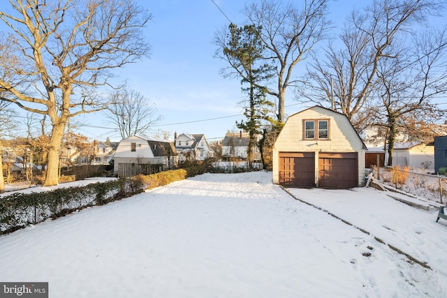 yard covered in snow featuring an outdoor structure