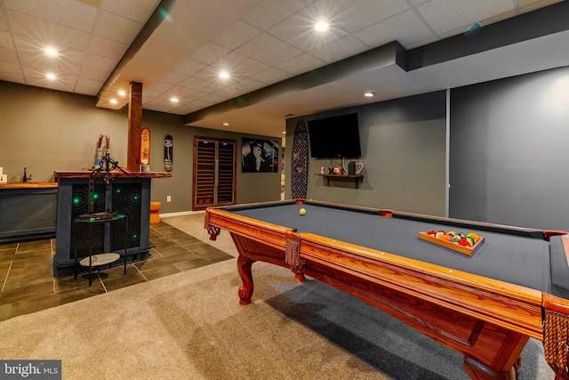 rec room with a paneled ceiling, pool table, and dark colored carpet