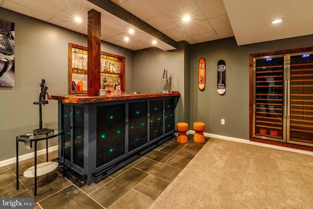 bar featuring a drop ceiling and wine cooler