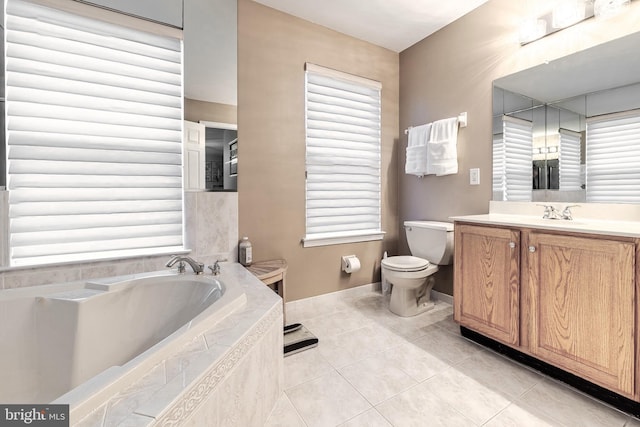 bathroom with tile patterned flooring, vanity, a relaxing tiled tub, and a wealth of natural light