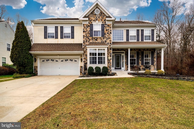 view of front of house with a front lawn, a porch, and a garage