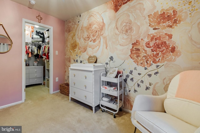 bedroom featuring carpet flooring, a spacious closet, and a closet