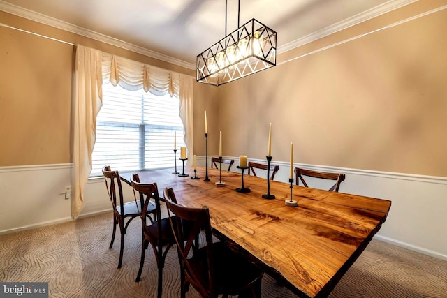 dining space with carpet floors and crown molding