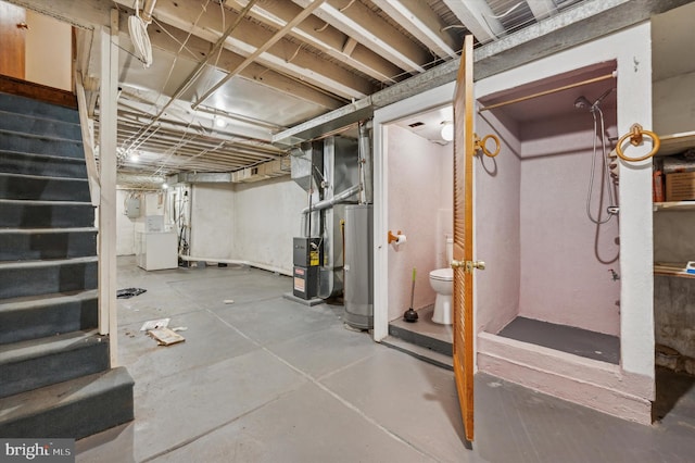 basement featuring washer / clothes dryer, heating unit, and gas water heater