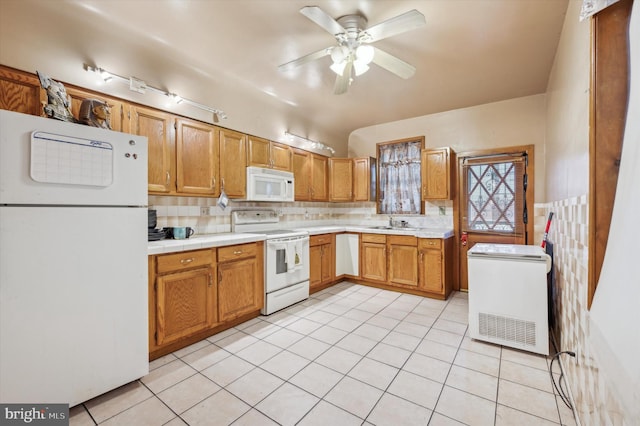 kitchen with ceiling fan, sink, light tile patterned floors, and white appliances