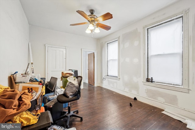 home office with ceiling fan and dark wood-type flooring