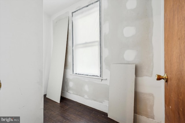 unfurnished room featuring dark hardwood / wood-style flooring