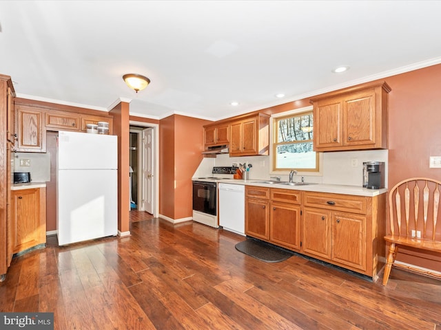 kitchen with dark hardwood / wood-style flooring, white appliances, crown molding, and sink