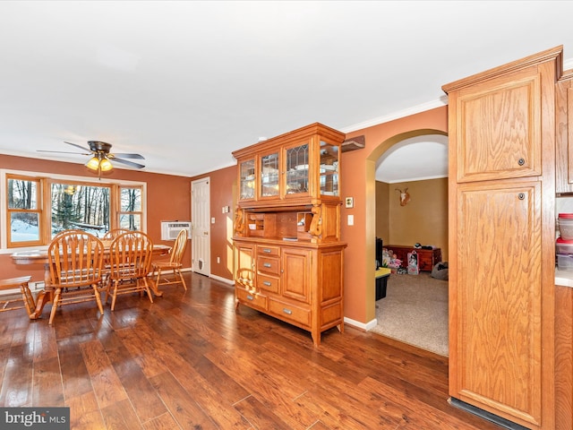 dining area featuring ceiling fan, dark hardwood / wood-style floors, ornamental molding, and a wall mounted AC