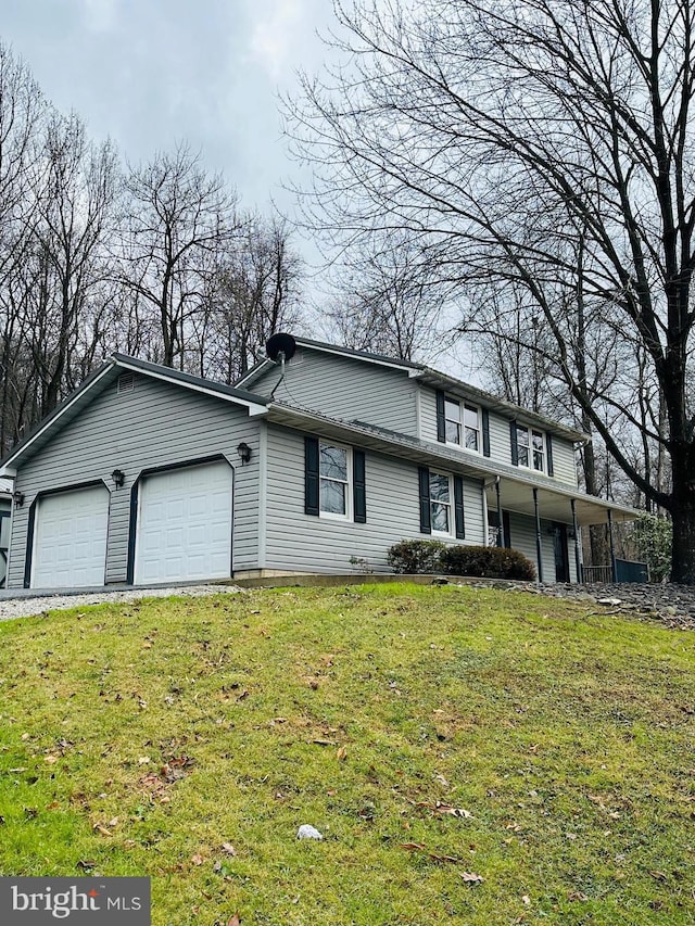 view of front of property featuring a garage and a front lawn