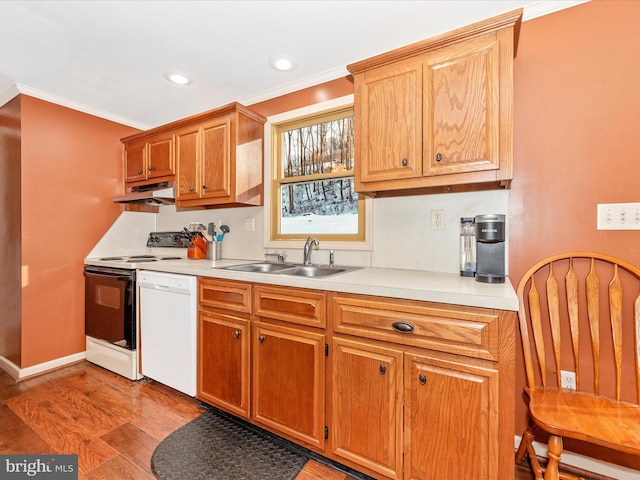 kitchen with white appliances, light hardwood / wood-style flooring, crown molding, and sink