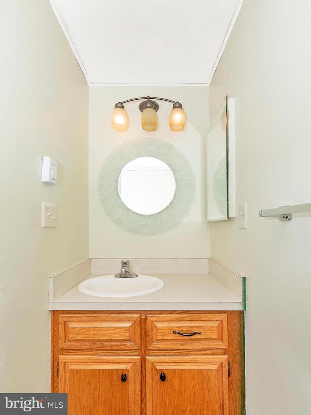 bathroom featuring vanity and ornamental molding