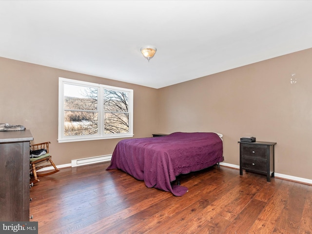 bedroom featuring dark hardwood / wood-style flooring and a baseboard radiator