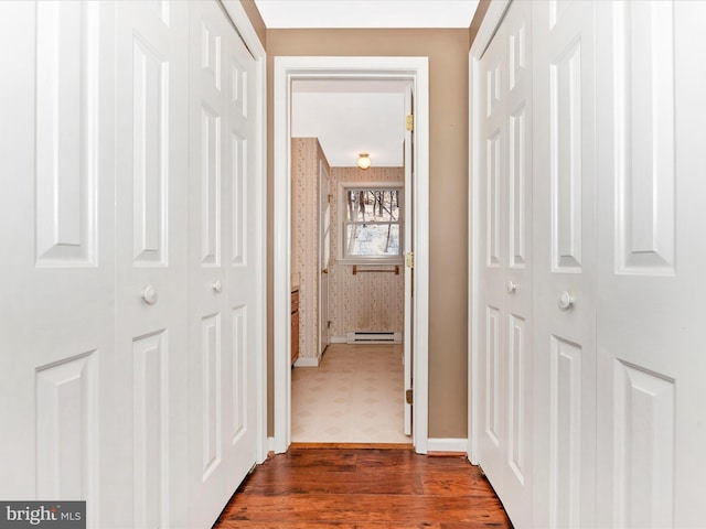 corridor featuring a baseboard radiator and dark hardwood / wood-style floors