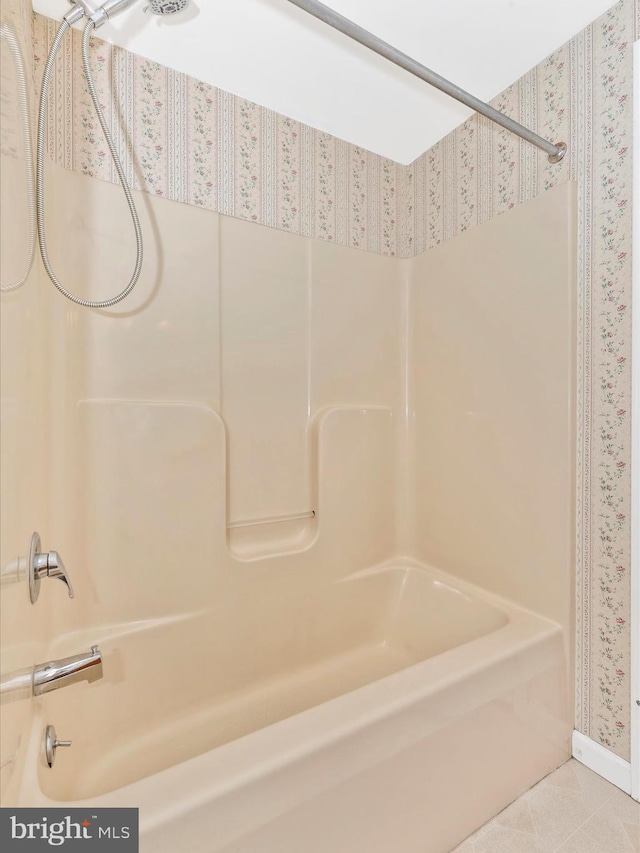 bathroom with tile patterned floors and bathing tub / shower combination