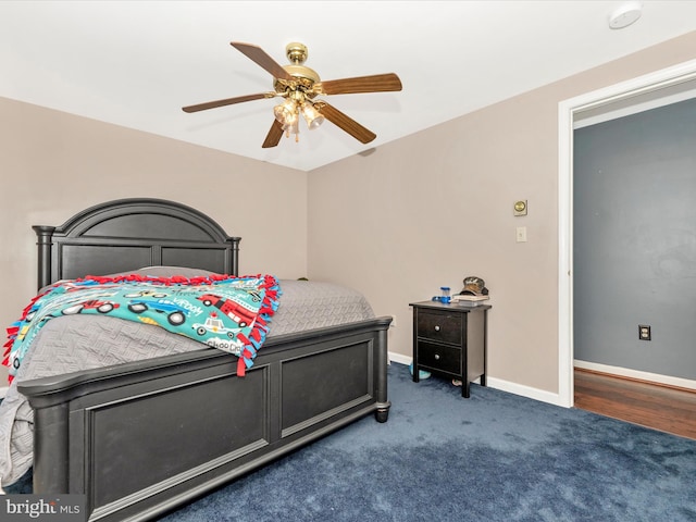 bedroom with dark colored carpet and ceiling fan