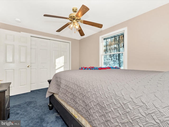 carpeted bedroom featuring ceiling fan and a closet