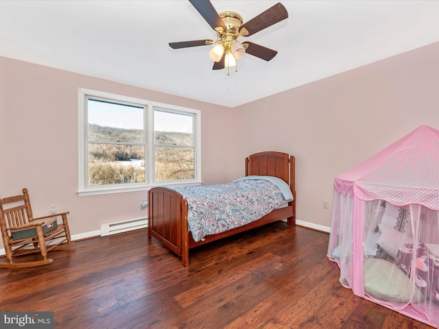 bedroom with ceiling fan, dark wood-type flooring, and a baseboard radiator