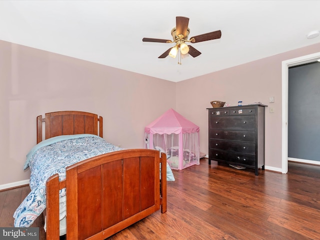 bedroom with ceiling fan and dark wood-type flooring