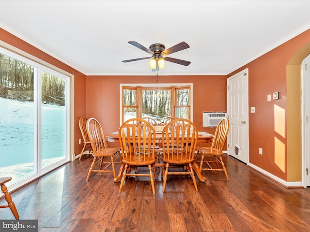 dining space with a wall mounted air conditioner, dark hardwood / wood-style flooring, ceiling fan, and ornamental molding