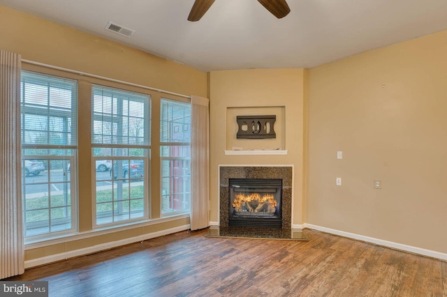 unfurnished living room with ceiling fan and wood-type flooring