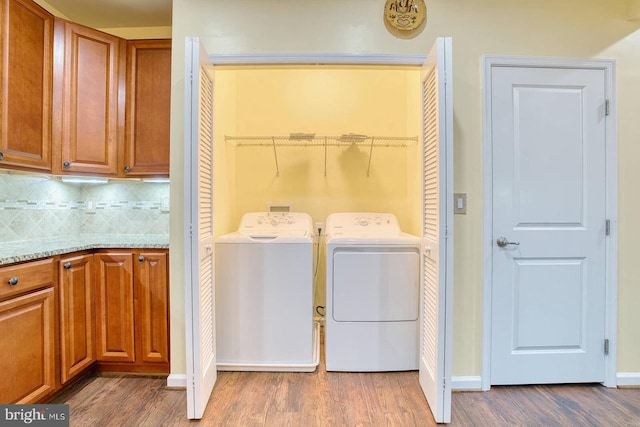 washroom with light hardwood / wood-style floors and independent washer and dryer